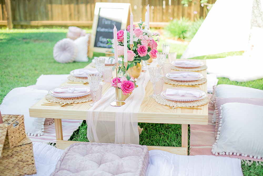 Friends sharing drinks on picnic blanket in Orange County